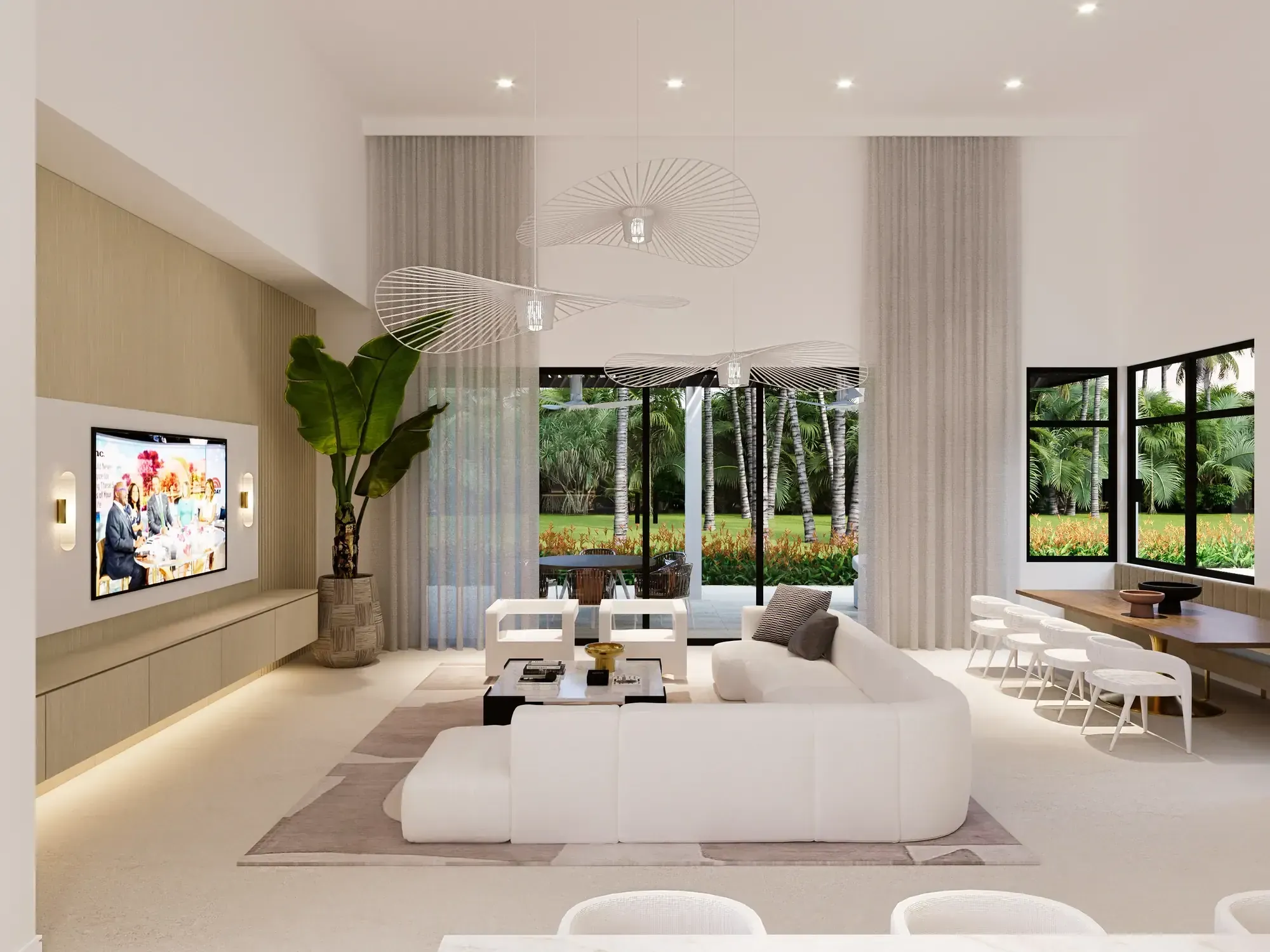 Family room at the Santander Residence in Southwest Ranches, Florida, with a white sectional, wall-mounted screen and wraparound garden views